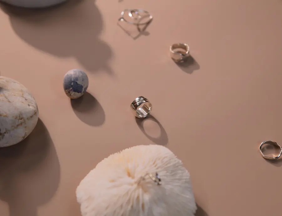 Silver ring beside a stone